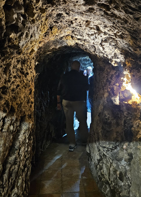 Inside the narrow cave hallway at Bodegas Lezaun
